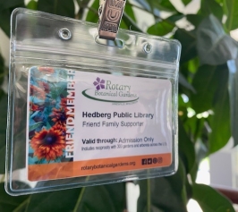 Rotary Gardens Guest Pass hanging in front of a plant