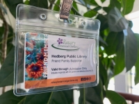 Rotary Gardens Guest Pass hanging in front of a plant
