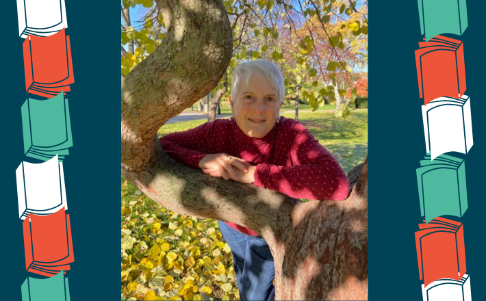woman with short gray hair leaning against tree