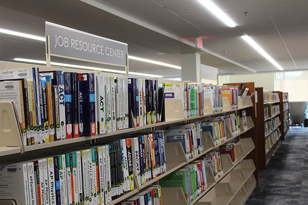 shelves of books with a sign that reads "job resource center"
