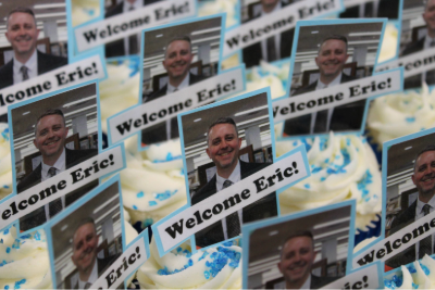 cupcakes with welcome eric and a picture of a man wearing a suit