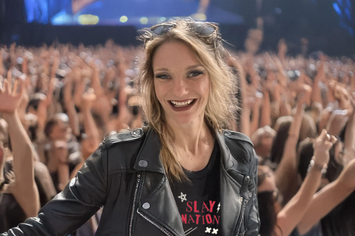 blonde woman wearing black leather jacket in front of a crowd