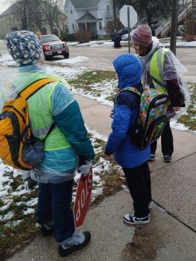 Adult and two children walking to school.
