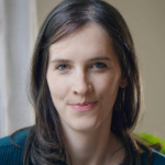 woman with dark hair looking at camera