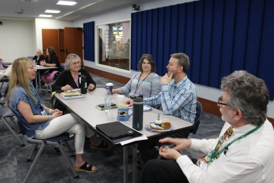men and women sitting around a table