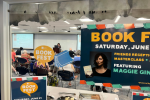 Book fest sign on a window looking into a workshop in seession