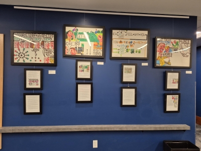 Four framed Staedtler marker drawings each with 2 framed narratives describing the pieces of artwork.
