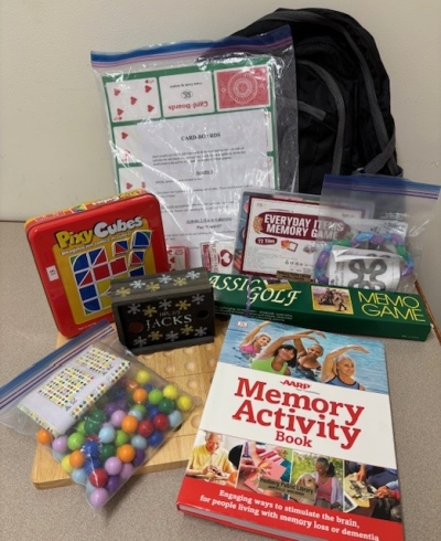 games, books and activities in front of a backpack