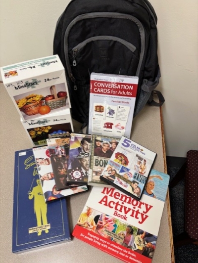 dvds books and activities in front of a backpack