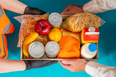 box of canned goods, milk, fruit, past, being handed from one person to another