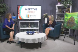 two women sitting in a studio talking about art