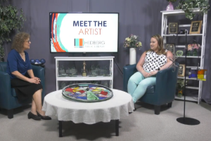 two women sitting in a studio talking about art