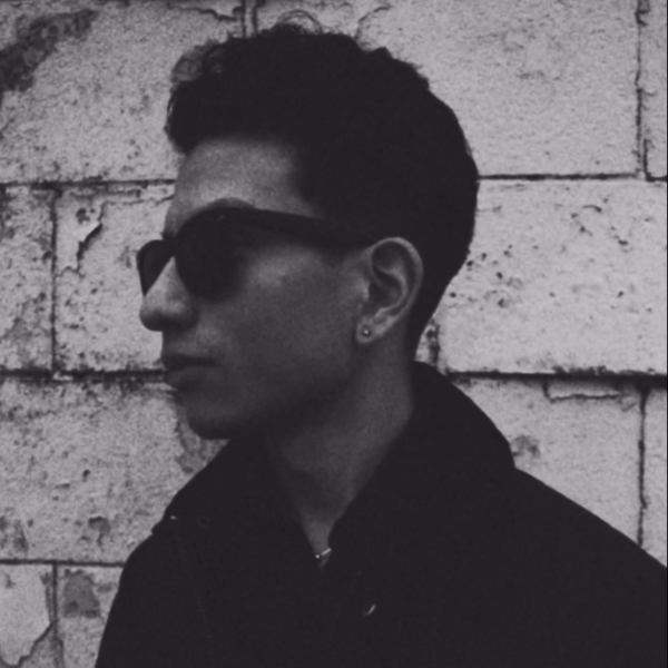 profile of man with black hair wearing black sunglasses