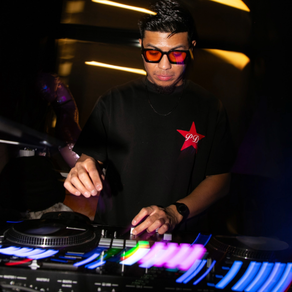 man with black hair wearing a black tshirt 