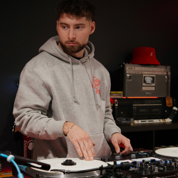 white man with brown hair and goatee wearing a grey sweatshirt