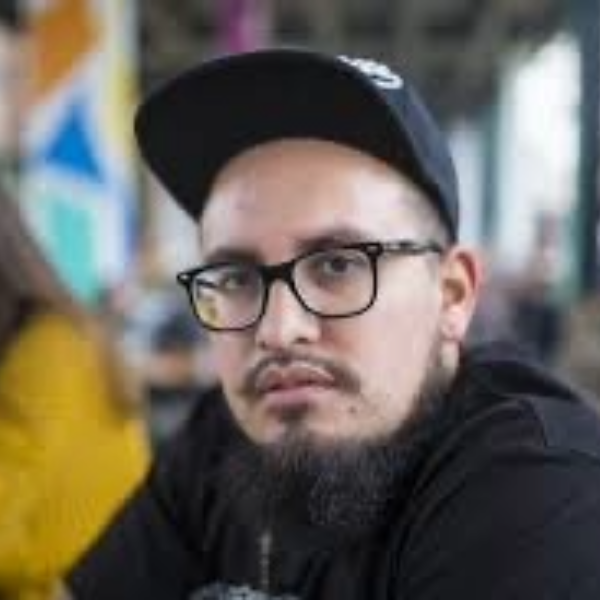 latino man with beard and mustache wearing a baseball cap and glasses