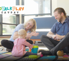 readtalkplayeveryday a mother and father sit with their infant 