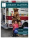 african american child holding blue bag and waving to the camera, standing in front of the library bookmobile and its mascot, mosi the giraffe