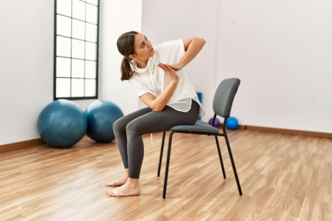 Woman performing yoga seated in chair