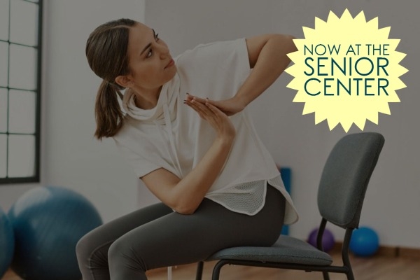 woman doing yoga while sitting on a chair