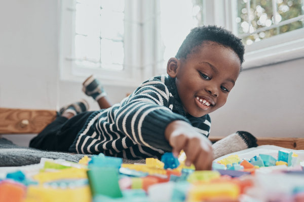 young african american boy playing with colorful blocks