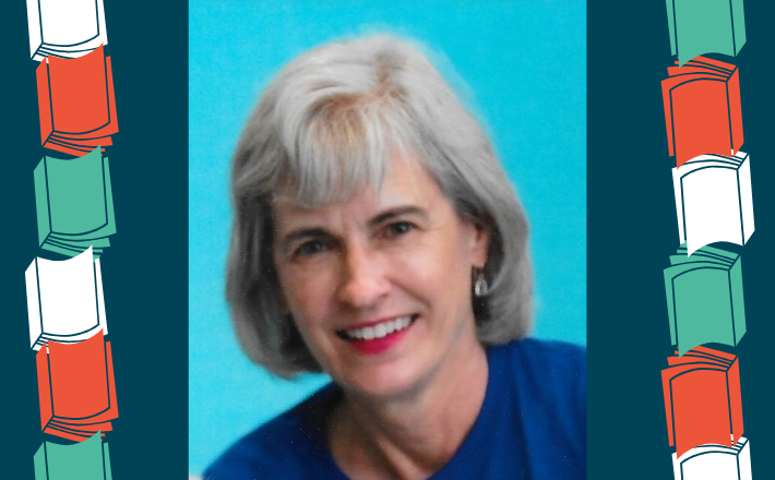 woman with short gray hair smiling at camera