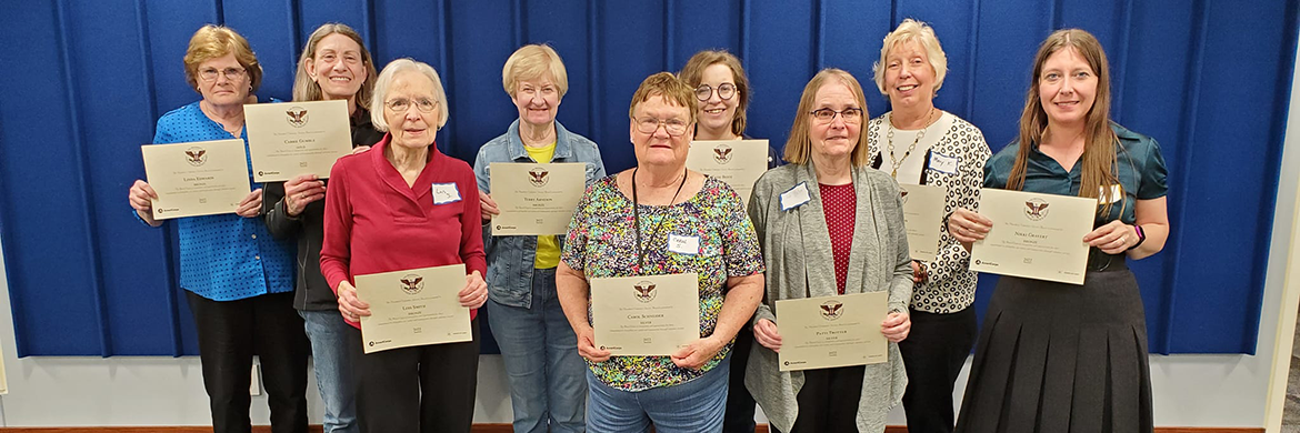 Friends Volunteer Group smiling and holding certificates