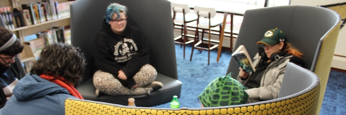 Teens in hive chairs in teen central
